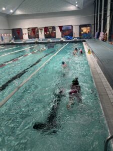 Jeunes qui nagent dans la piscine de la Cour des Lions.